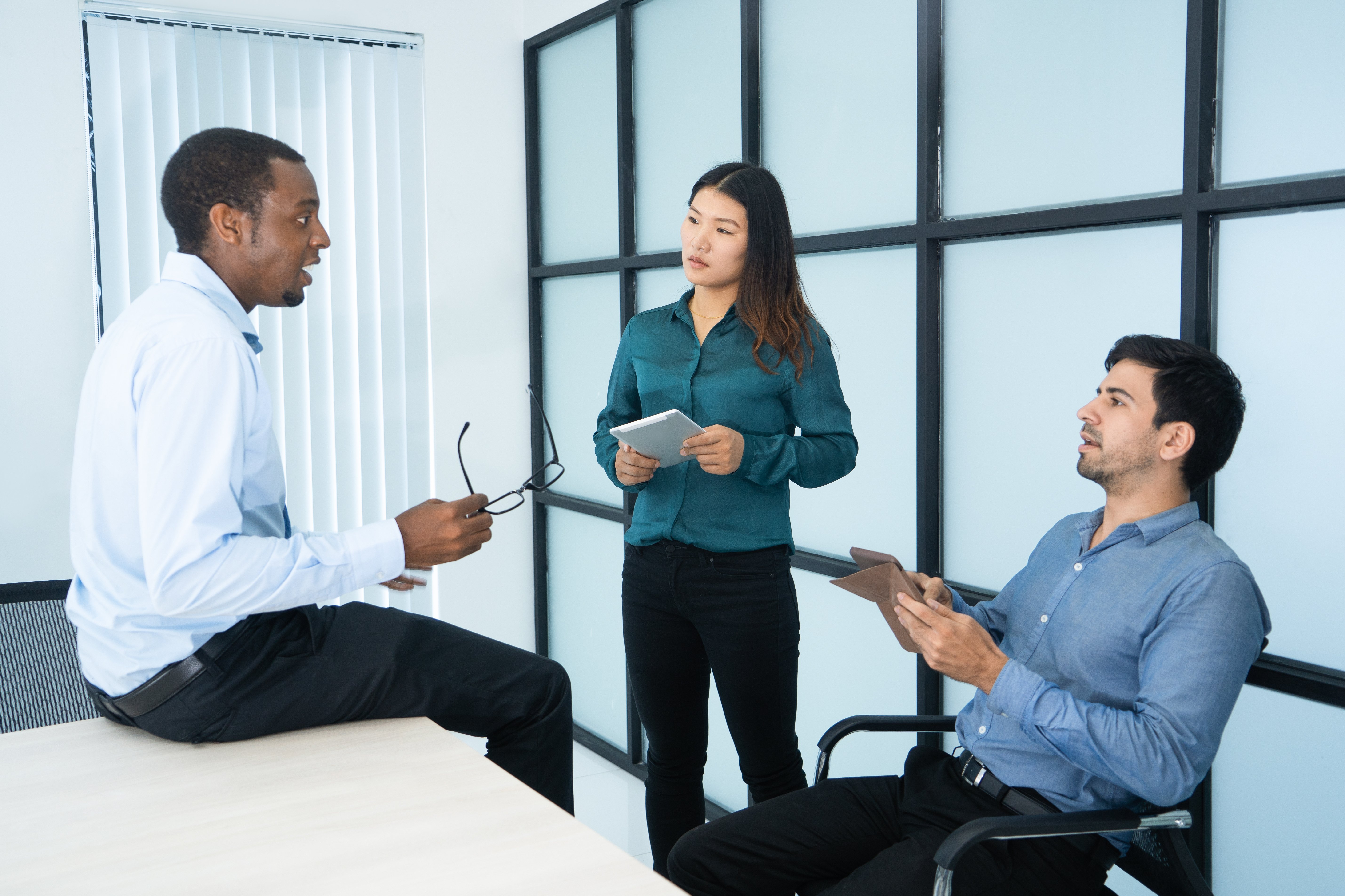 Thoughtful multiethnic managers arguing about strategy